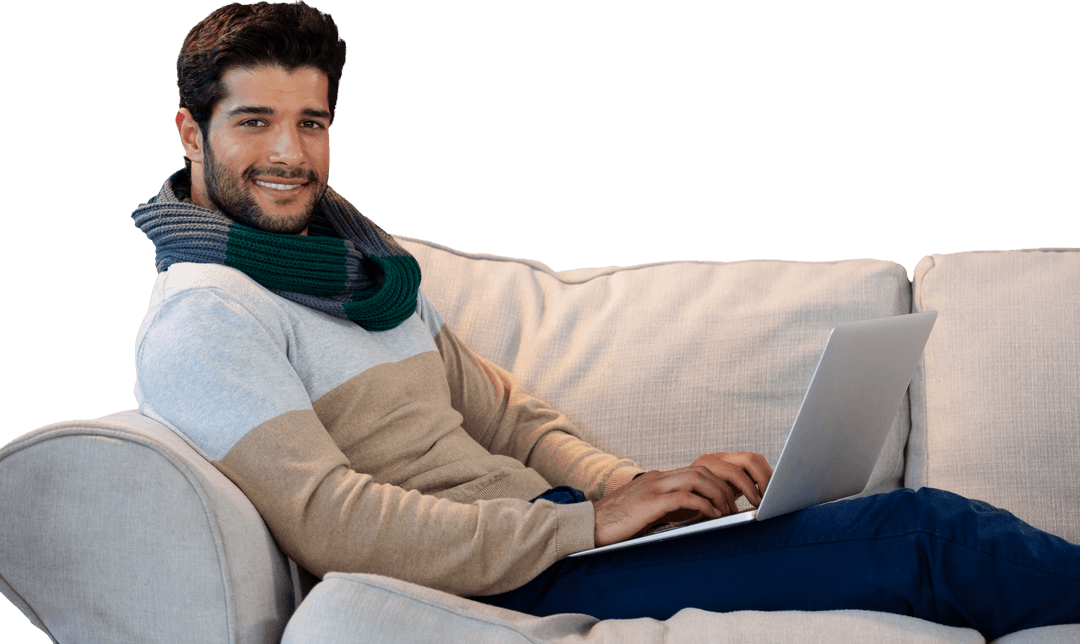 Smiling Man with Laptop Relaxing on Sofa in Casual Outfit