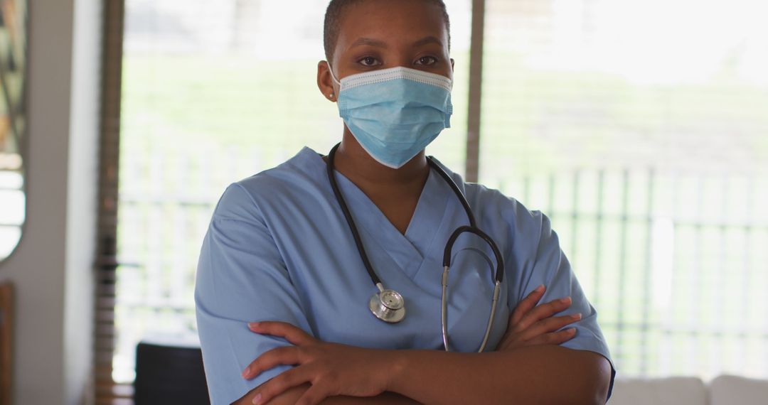 Professional Nurse Standing with Arms Crossed in Medical Facility - Free Images, Stock Photos and Pictures on Pikwizard.com