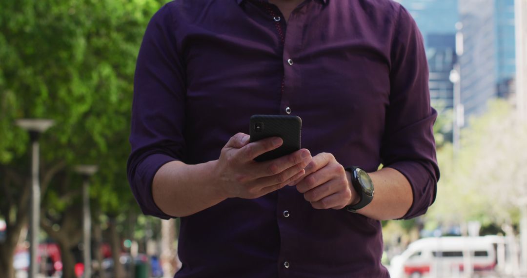 Man in Purple Shirt Using Smartphone Outdoors in Urban Area - Free Images, Stock Photos and Pictures on Pikwizard.com