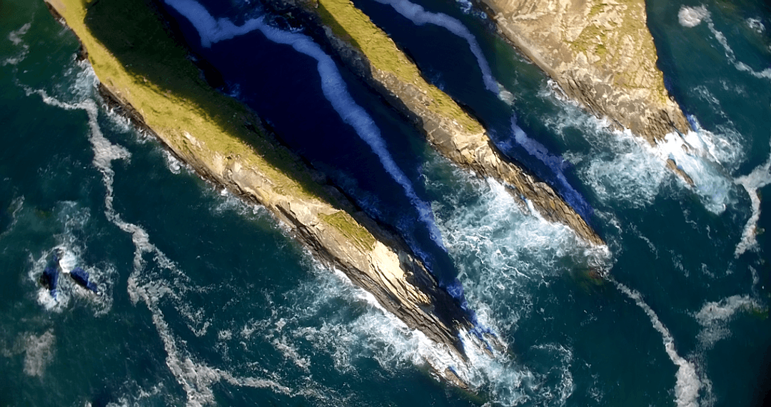 Stunning Aerial View of Rock Formations by Transparent Sea Waters