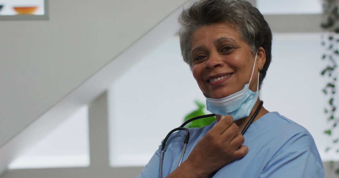 Smiling African American Nurse Adjusting Stethoscope in Hospital - Free Images, Stock Photos and Pictures on Pikwizard.com