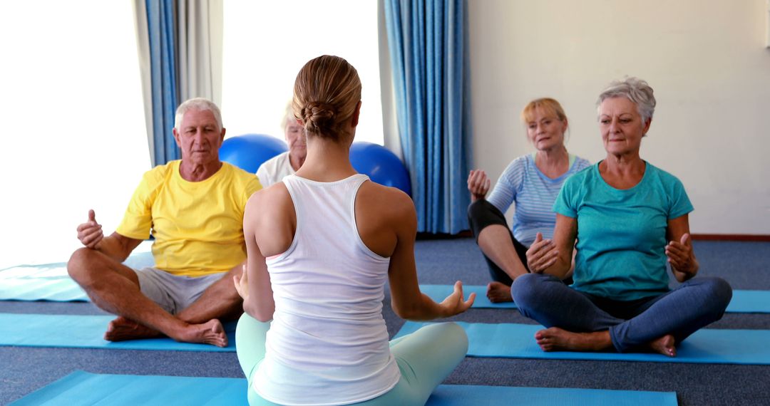 Yoga Instructor Guiding Senior Group in Home Fitness Session - Free Images, Stock Photos and Pictures on Pikwizard.com