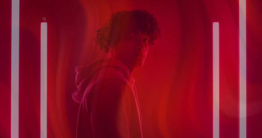 Stylish Man in Red Lighting with Neon Tubes