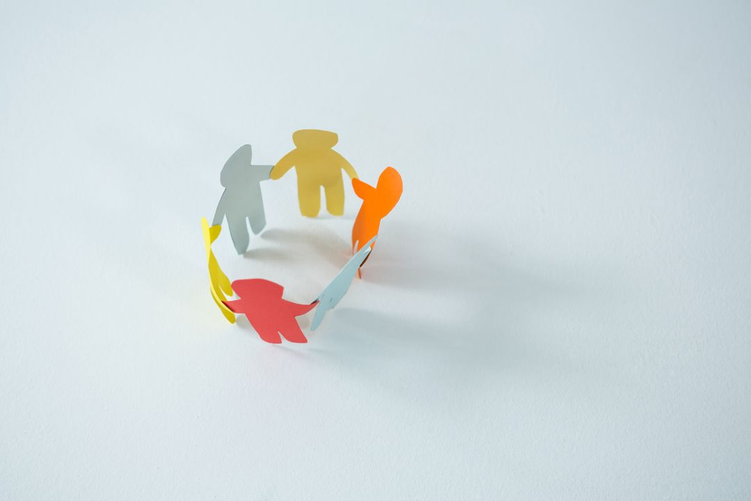 Circle of multicolored paper cut-out figures - Free Images, Stock Photos and Pictures on Pikwizard.com