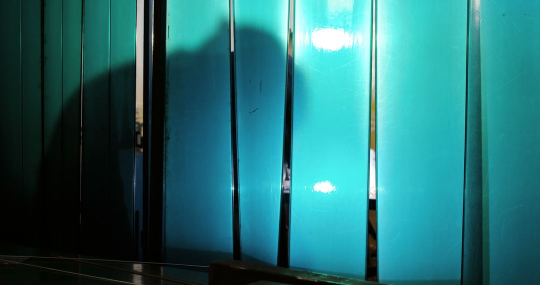 Mysterious Shadow on Blue Transparent Panels - Free Images, Stock Photos and Pictures on Pikwizard.com