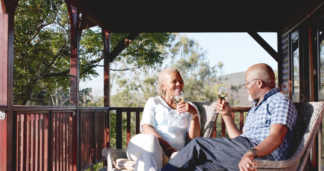 Senior Couple Relaxing on Patio with Wine in Daylight