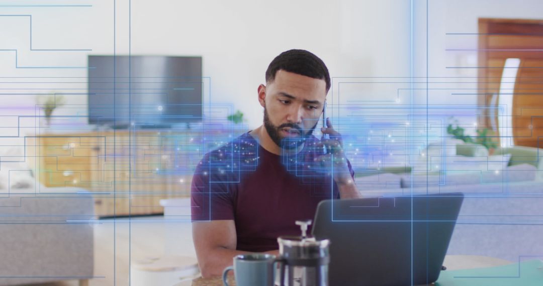 Man Engaging in Remote Work with Laptop and Smartphone at Home