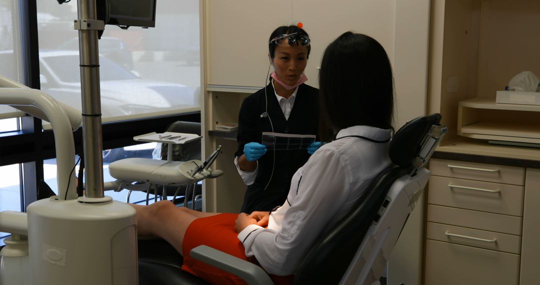 Dental Hygienist Talking to Patient in Modern Dental Clinic - Free Images, Stock Photos and Pictures on Pikwizard.com