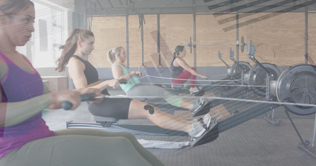 Women Using Rowing Machines With Digital Data Overlay