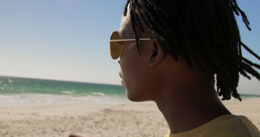 Man Wearing Sunglasses Enjoying Serene Beach View