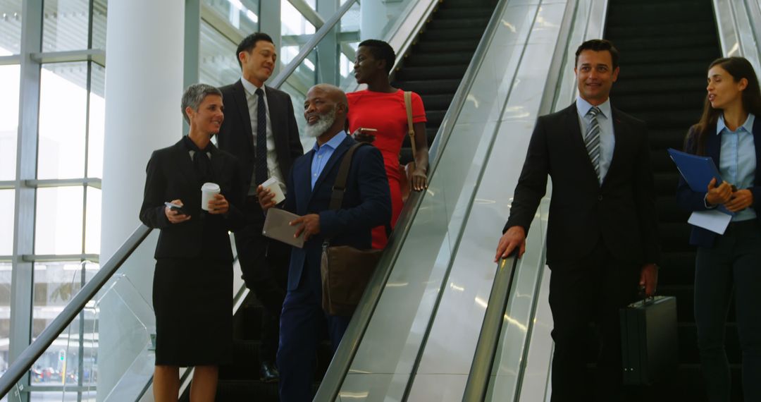 Diverse Business Professionals Using Escalators - Free Images, Stock Photos and Pictures on Pikwizard.com