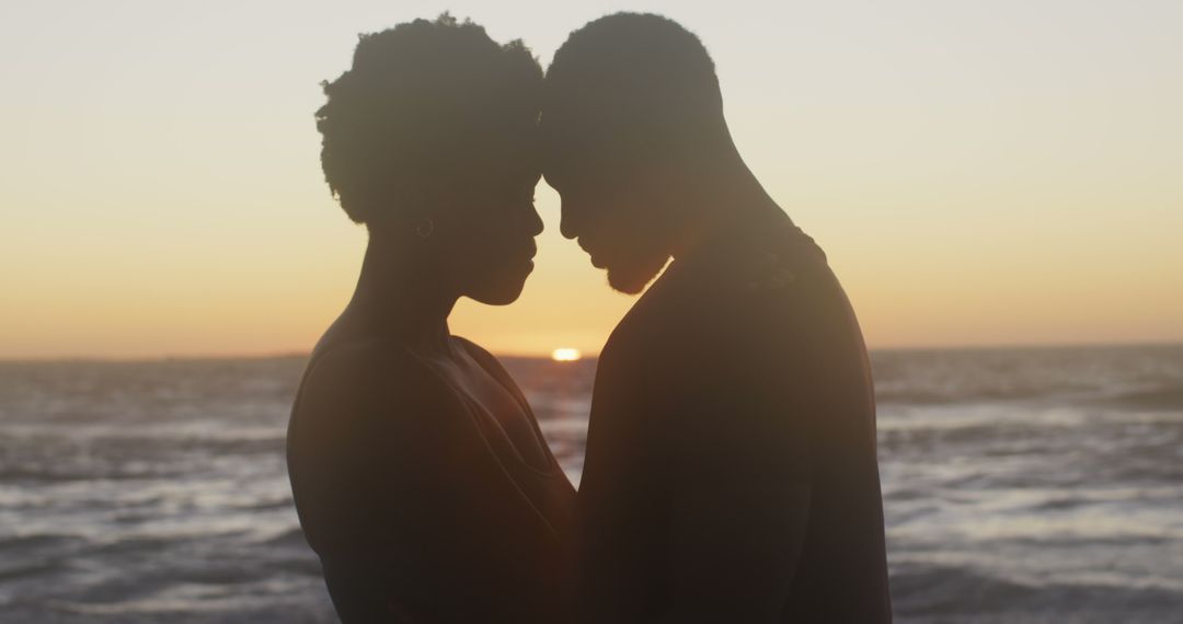 Romantic Couple Embracing at Sunset, Silhouette Against Ocean - Free Images, Stock Photos and Pictures on Pikwizard.com