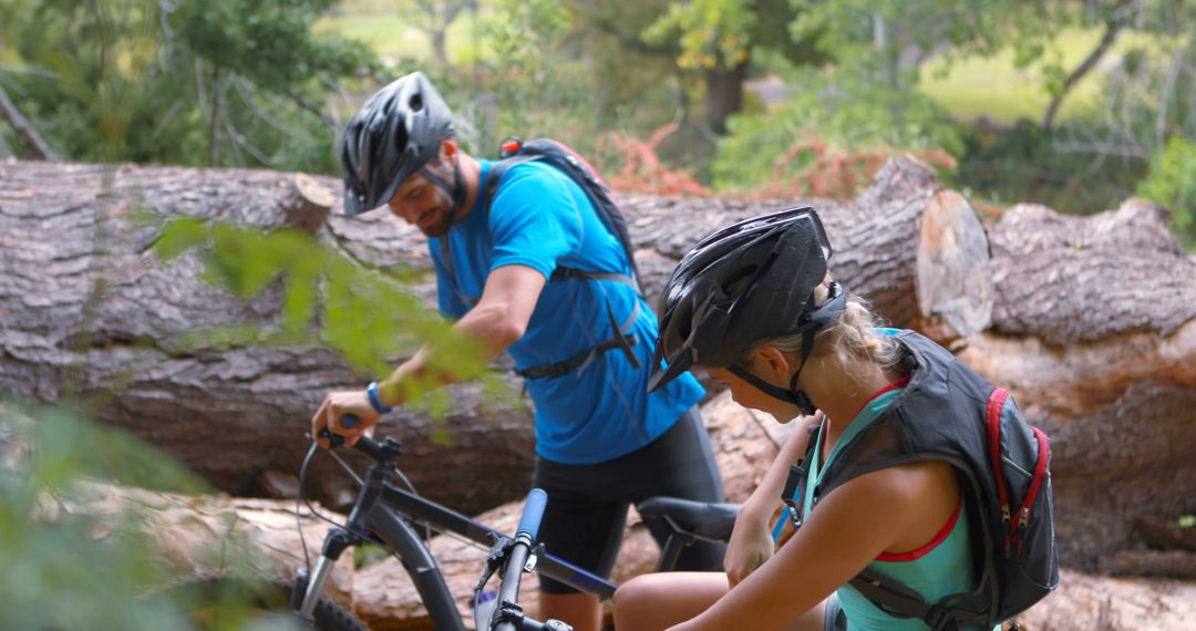 Couple Preparing for Mountain Biking Adventure in Forest
