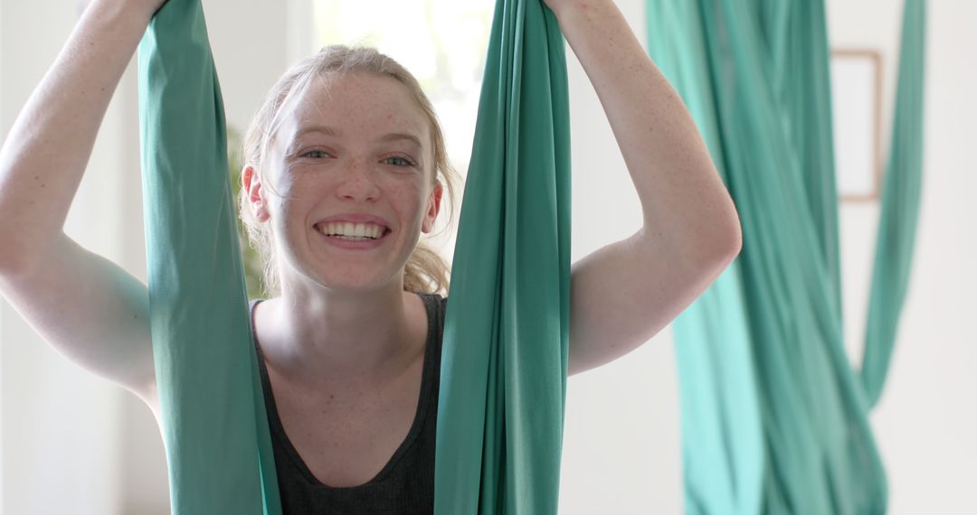 Smiling Teenage Girl Enjoying Aerial Yoga Class - Free Images, Stock Photos and Pictures on Pikwizard.com