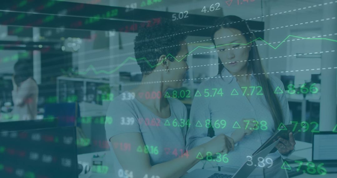 Two Women Analyzing Data with Stock Market Overlay in Modern Office