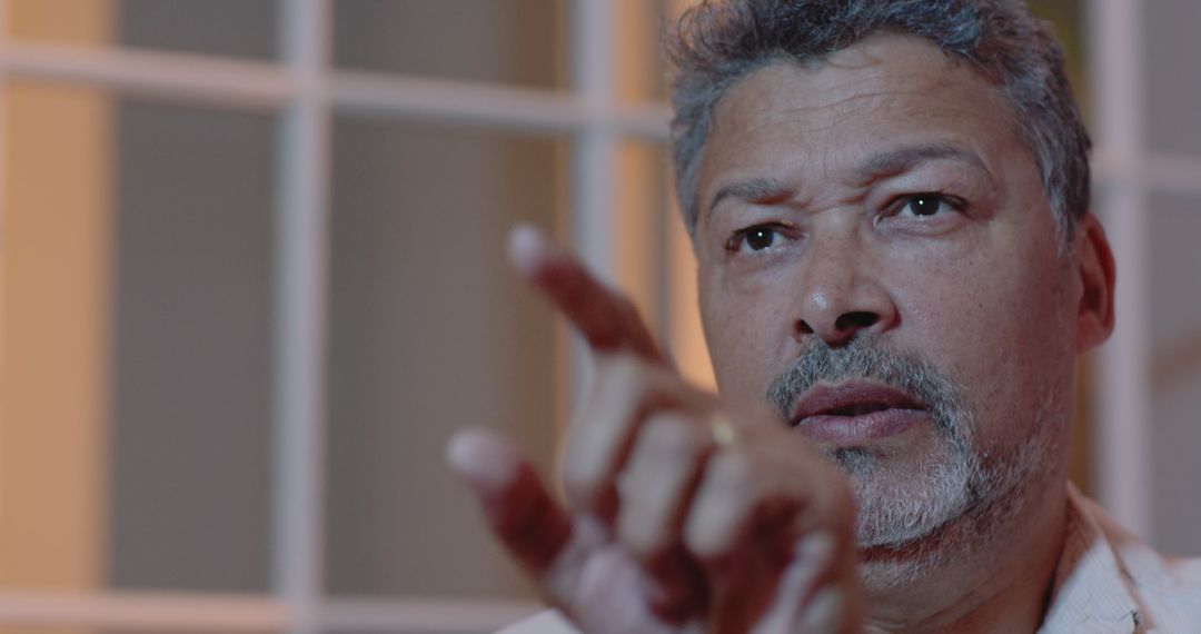 Senior Man Engaging in Thoughtful Conversation at Home