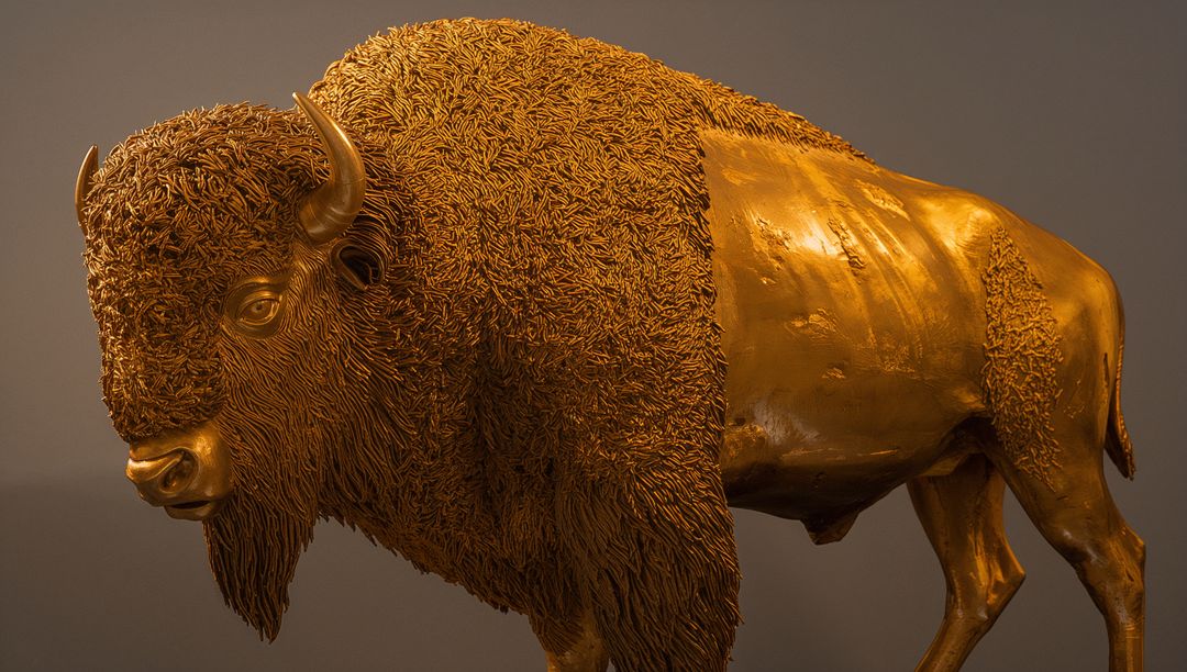 Bronze Bison Sculpture Displaying Textured Mane and Polished Patina Under Gallery Light