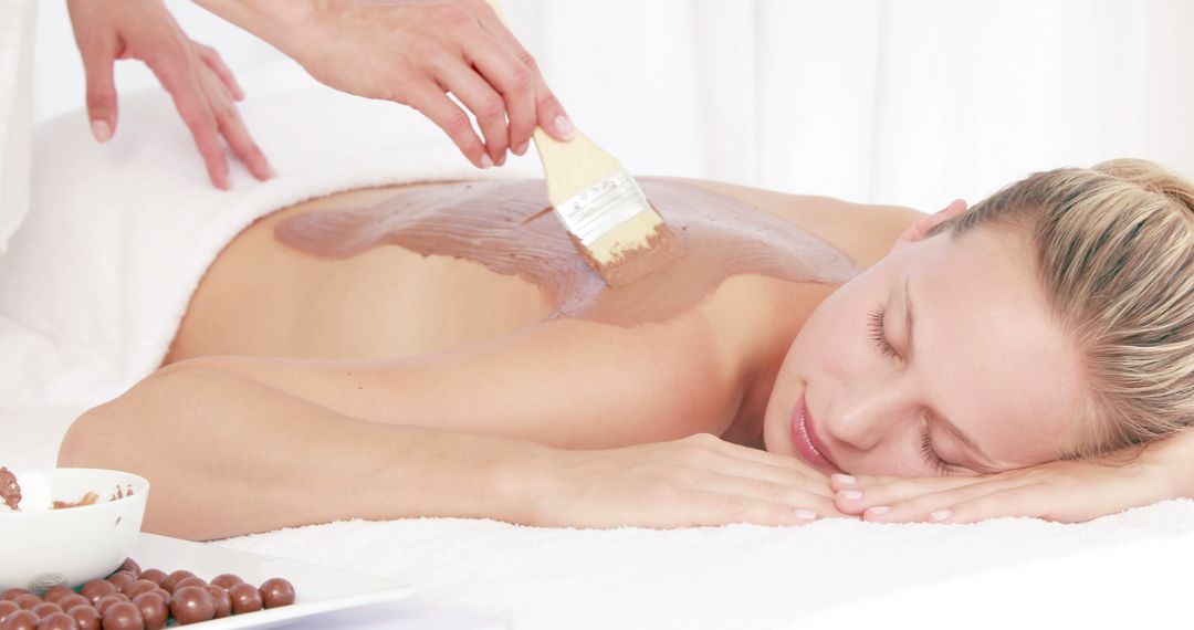 A young Caucasian woman enjoys a chocolate spa treatment, with copy space - Free Images, Stock Photos and Pictures on Pikwizard.com