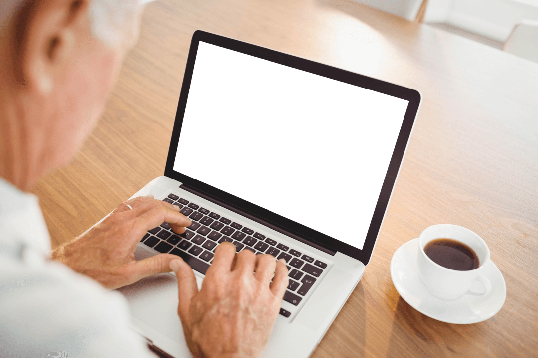 Elderly Man Typing on Transparent Laptop with Coffee Cup