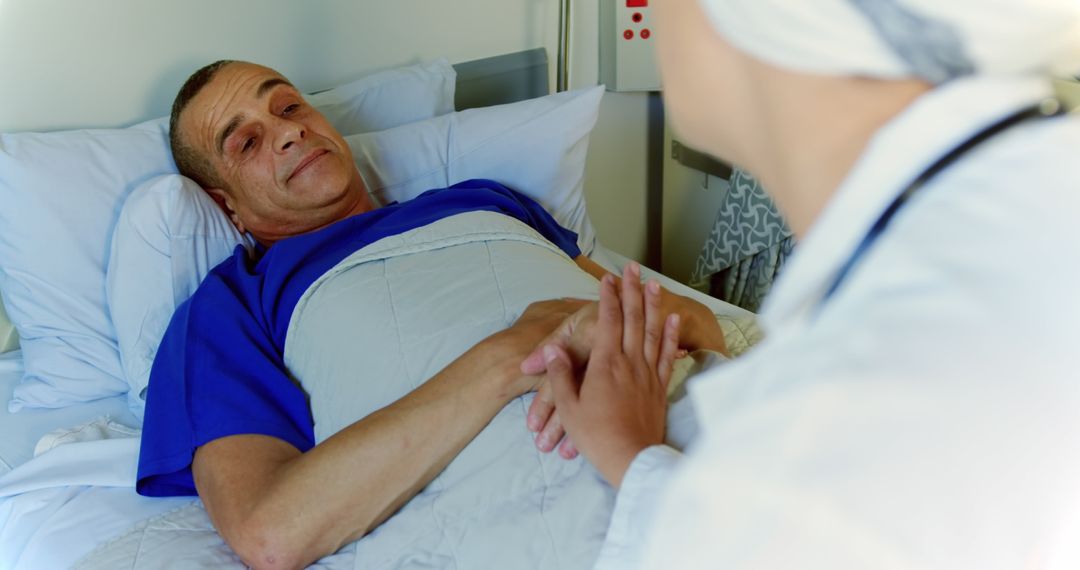 Male Patient in Hospital Bed Holding Hands with Female Doctor - Free Images, Stock Photos and Pictures on Pikwizard.com