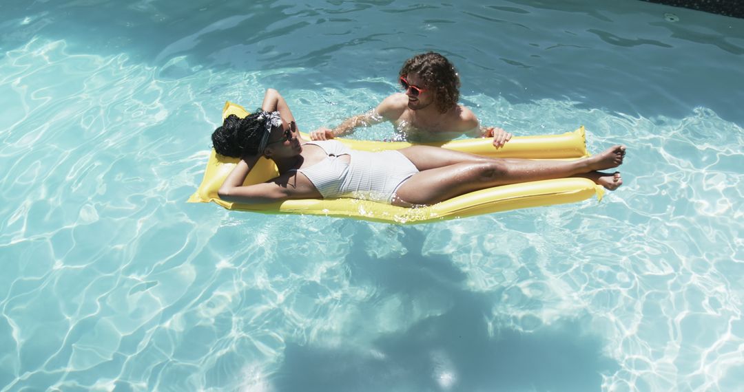Relaxing Pool Day for a Diverse Couple Enjoying Summer Sunshine