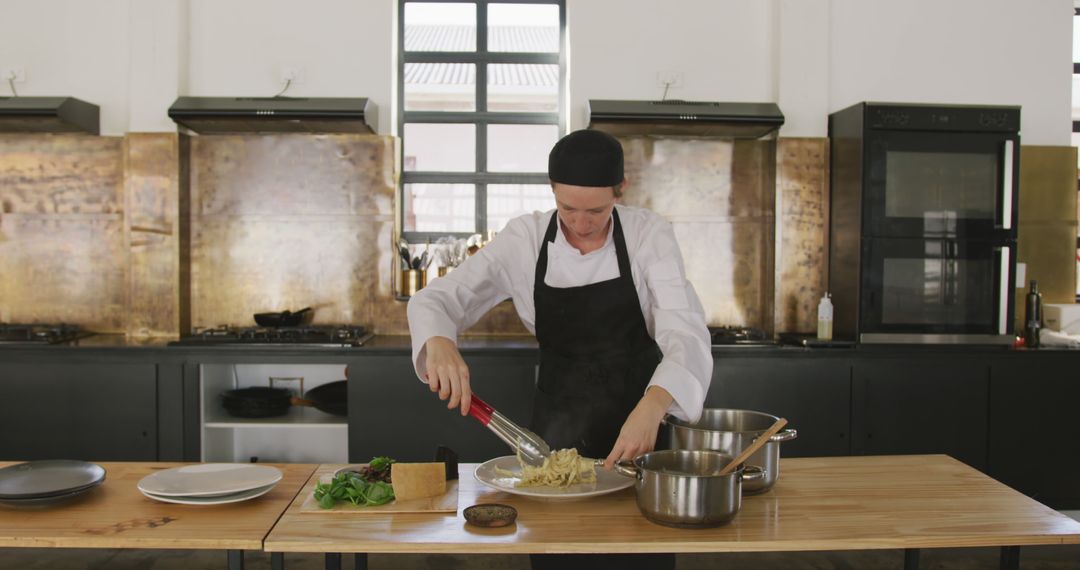 Chef Plating Pasta Dish in Modern Kitchen - Free Images, Stock Photos and Pictures on Pikwizard.com