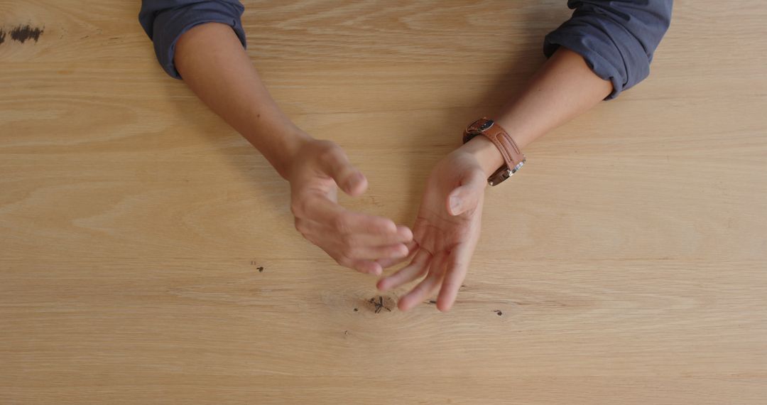 Hands of Professional Preparing for Meeting at Wooden Desk