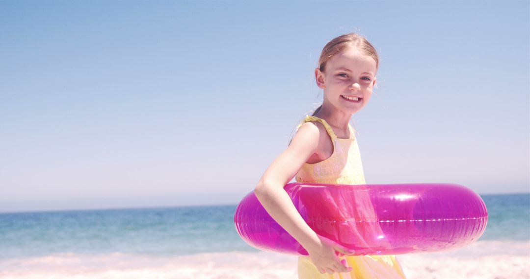 Smiling Girl with Inflatable Ring at Beach - Free Images, Stock Photos and Pictures on Pikwizard.com