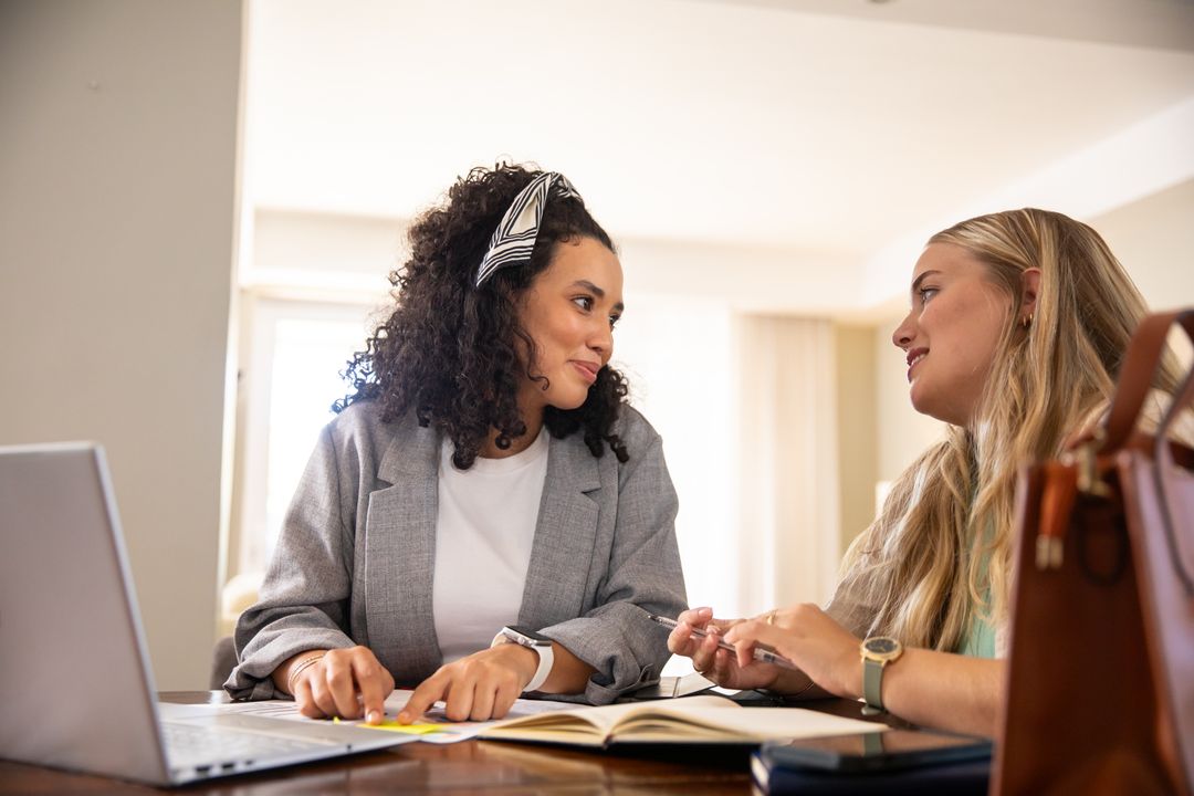 Professional Female Colleagues Collaborating on Workplace Project