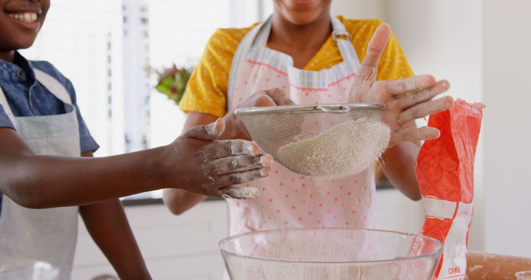 Mother and Child Sifting Flour in Kitchen Preparing Dough Together - Free Images, Stock Photos and Pictures on Pikwizard.com