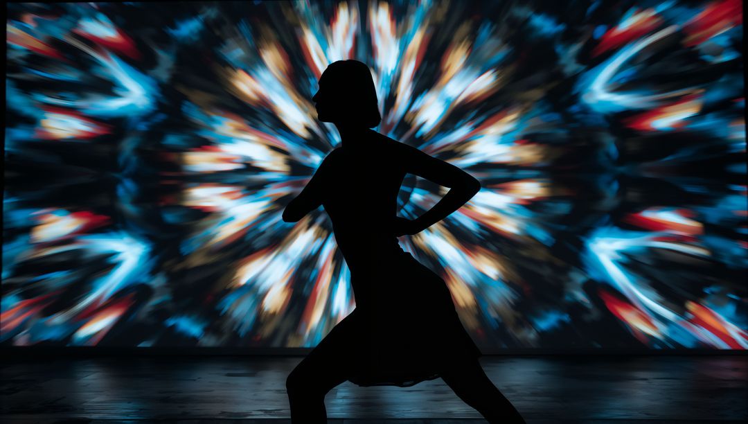 Silhouette of Dancer with Vibrant Kaleidoscope Projection