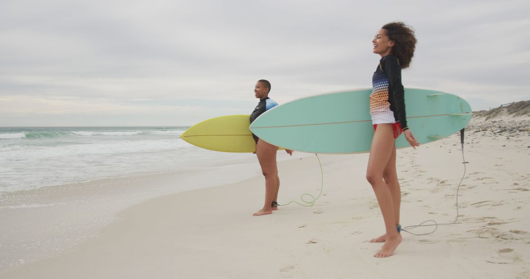 Two Surfers Standing on Beach Holding Surfboards - Free Images, Stock Photos and Pictures on Pikwizard.com