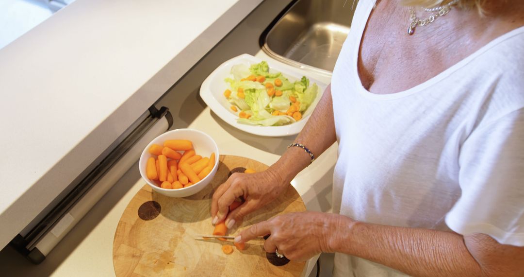 Close-Up of Person Preparing Fresh Vegetable Salad in Kitchen - Free Images, Stock Photos and Pictures on Pikwizard.com