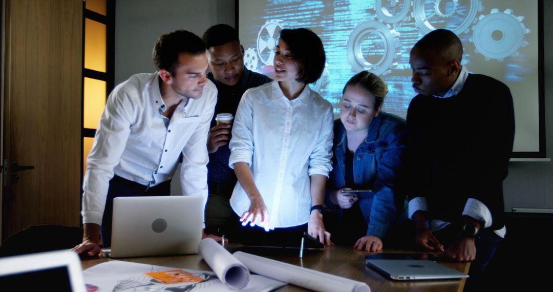 Diverse Executives Collaborating on Tablet in Modern Office