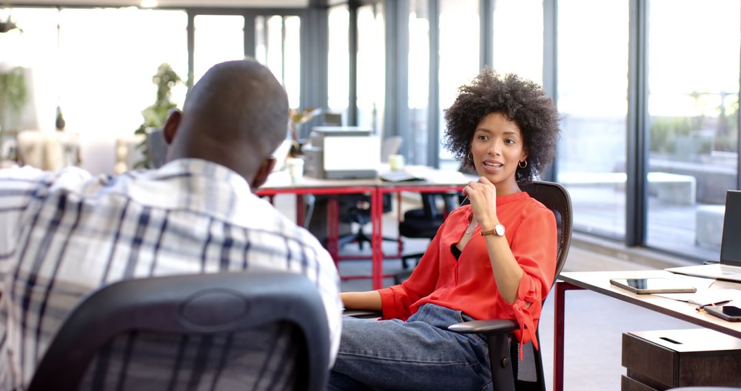 Diverse Colleagues Discuss Strategy in Relaxed Office Environment