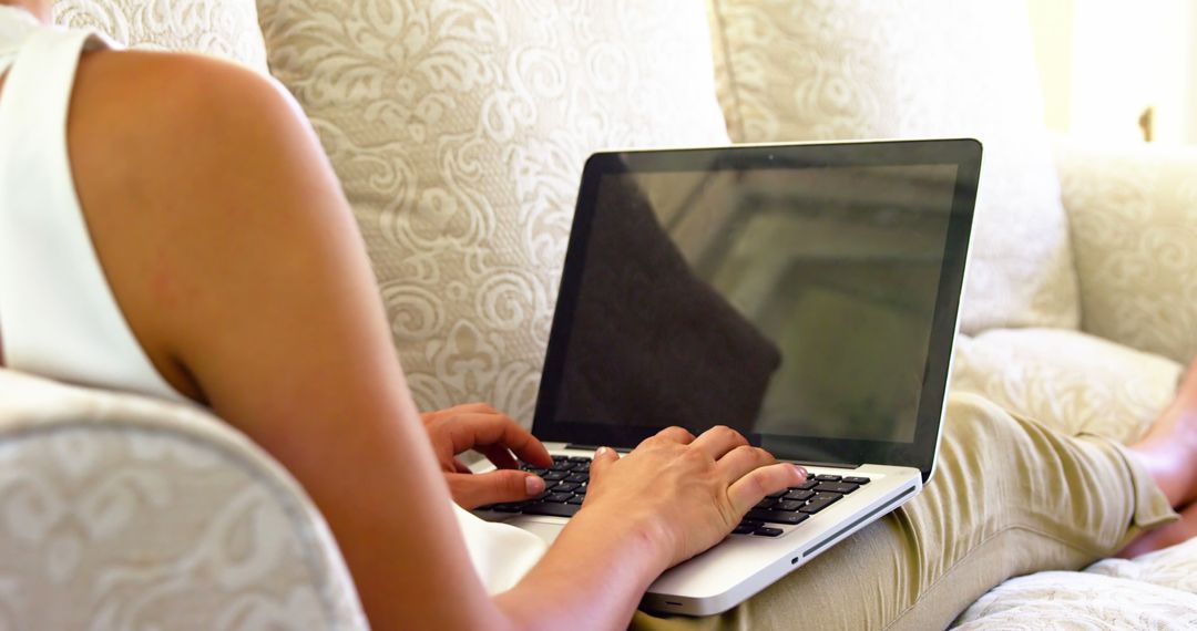 Woman Relaxing on Sofa Typing on Laptop - Free Images, Stock Photos and Pictures on Pikwizard.com