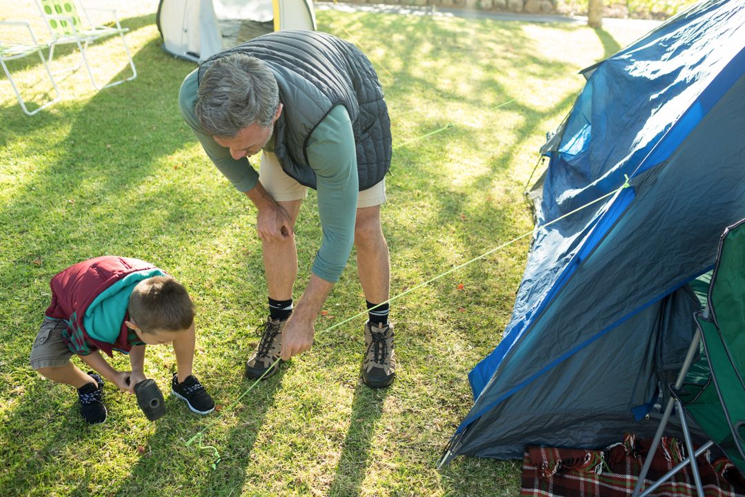 Grandfather and Grandson Setting Up Camping Tent - Free Images, Stock Photos and Pictures on Pikwizard.com