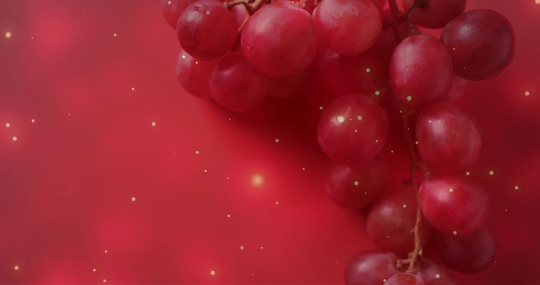 Red Grapes Against Pink Gradient with Sparkling Light