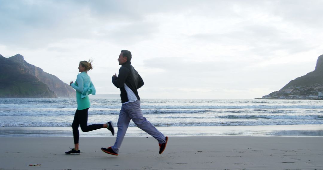 Couple Jogging on Beach During Relaxing Morning Workout - Free Images, Stock Photos and Pictures on Pikwizard.com