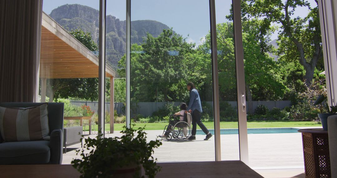 Caring Father Pushing Son in Wheelchair Outside Home - Free Images, Stock Photos and Pictures on Pikwizard.com