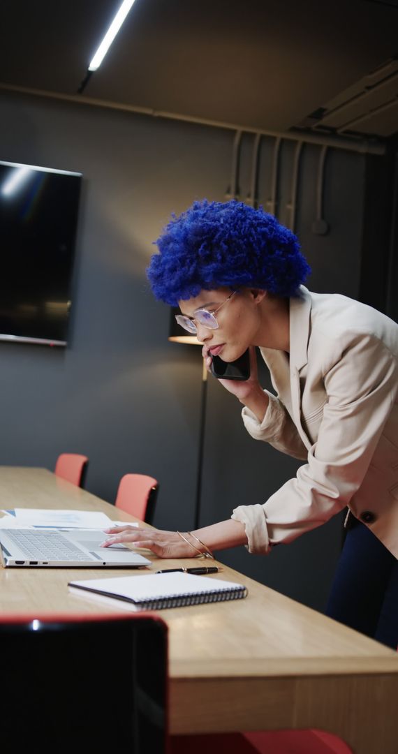 Young Professional with Blue Hair in Business Meeting Room Consulting Documents - Free Images, Stock Photos and Pictures on Pikwizard.com