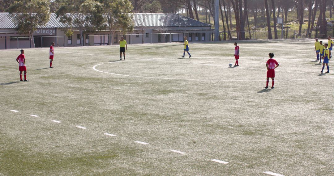 Youth soccer practice on sunlit field, promoting teamwork and physical fitness