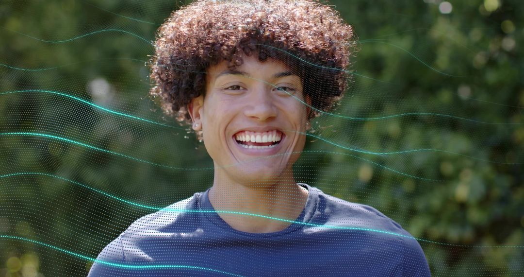 Smiling young man wearing navy shirt and stud earrings facing camera with teal overlay