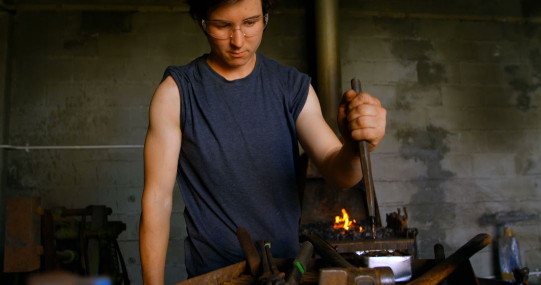 Focused Female Metalsmith Crafting in Industrial Workshop - Free Images, Stock Photos and Pictures on Pikwizard.com