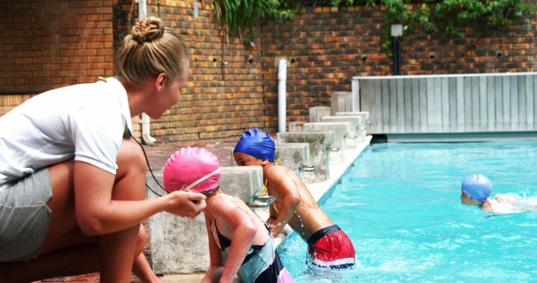 Swimming Lessons by Female Instructor at Outdoor Pool - Free Images, Stock Photos and Pictures on Pikwizard.com