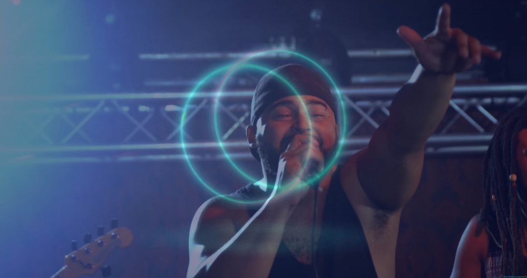 Dynamic Male Vocalist Energizing Audience During Live Concert