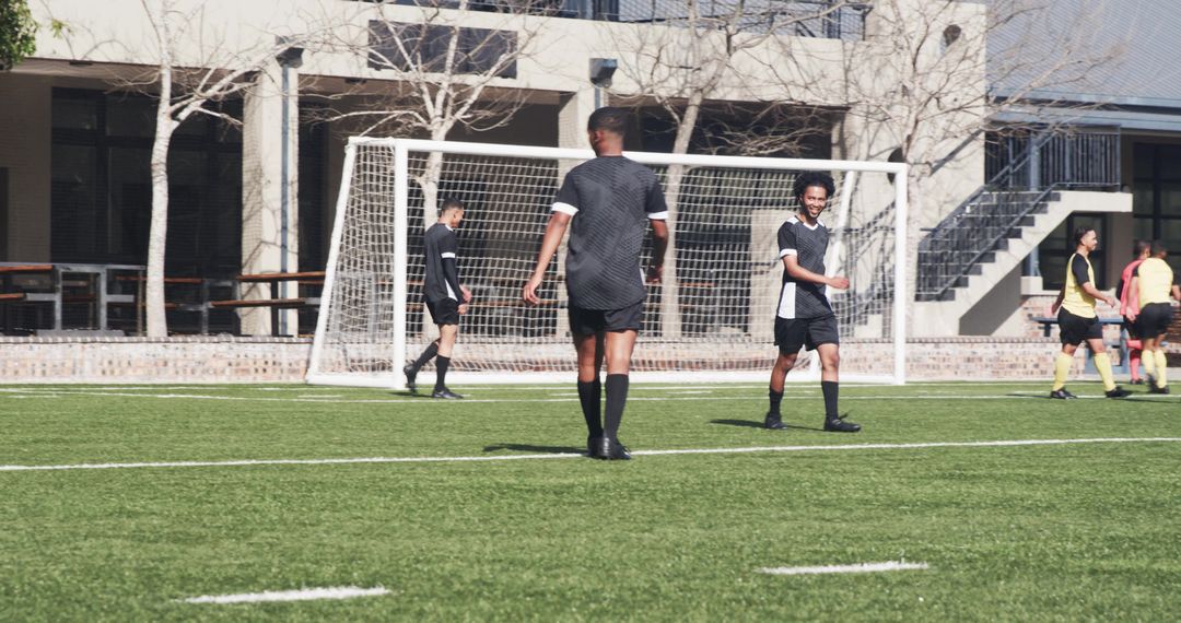 Soccer Team Strategizing During Outdoor Practice on Sunny Field