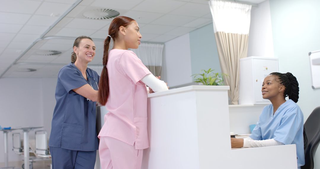 Diverse Healthcare Professionals Conversing at Reception Desk