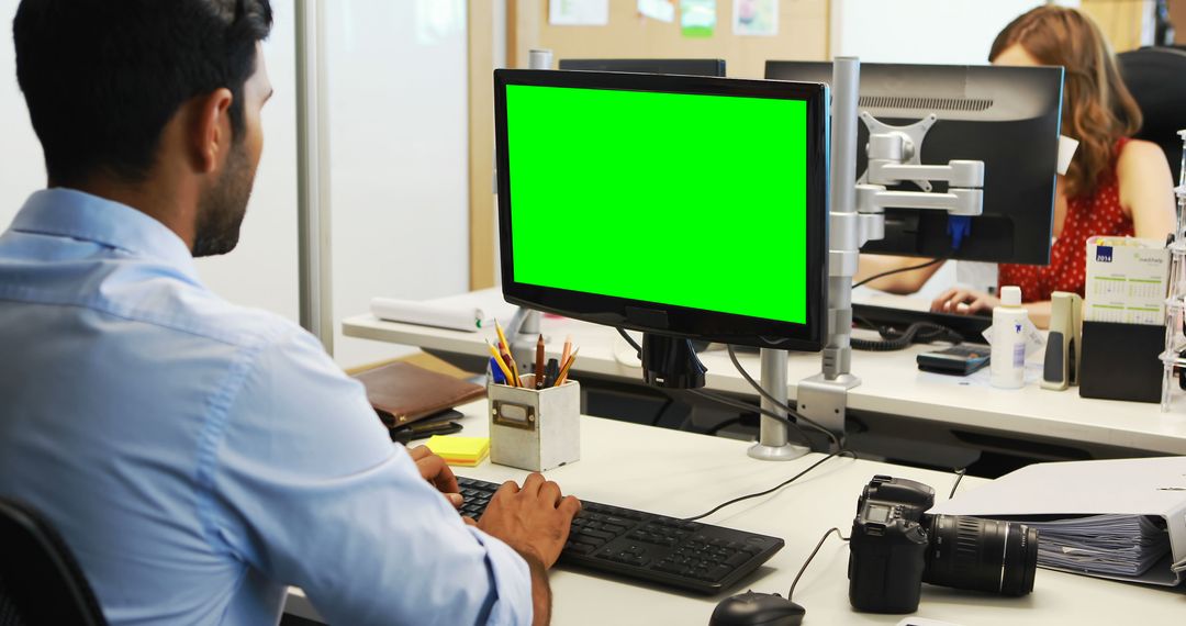 Asian Professional Working on Chroma Key Desktop in Modern Office