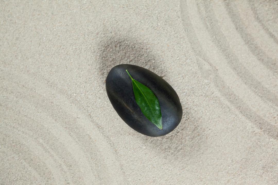 Leaf on Black Pebble Stone in Zen Garden Sand - Free Images, Stock Photos and Pictures on Pikwizard.com